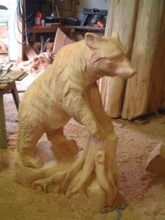 a wooden carving of a bear in a workshop