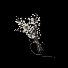 a bouquet of white flowers tied to a black background with the word love written on it