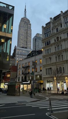 a city street with tall buildings in the background