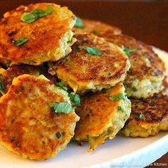 several crab cakes on a white plate with green garnish and text overlay that reads squash croquettes