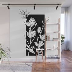 a black and white floral wall mural in a living room with wooden flooring next to a ladder