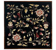 a black rug with flowers and leaves on the border is shown in this image, it has