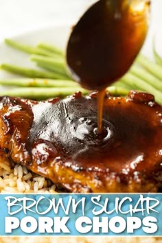 brown sugar pork chops being drizzled with sauce on top of rice