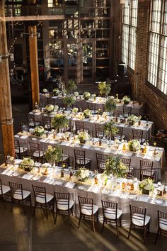 the tables are set with white and green centerpieces for an elegant wedding reception