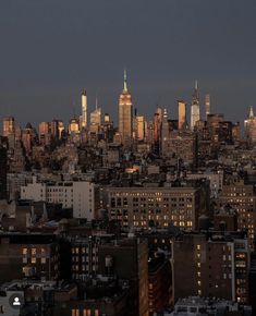 the city skyline is lit up at night