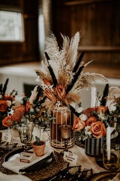 the centerpieces are adorned with feathers and flowers, along with candlesticks