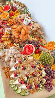 a table topped with lots of different types of food and pastries on top of it