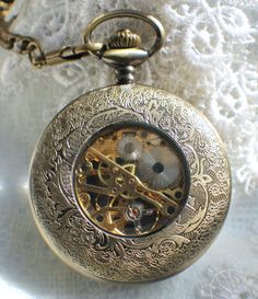 "Dragon pocket watch, men's mechanical pocket watch with a dragon theme. Pocket watch features a 13\" bronze dragon watch fob, dragon is 6 1/2\". The watch has a black dial featuring silver numerals. This is a mechanical self wind watch that needs no batteries. The watch case is a rich bronze and front cover opens to reveal watch face, you can see the gold cogs and inner watch workings on the back of the watch.. This bold and unique pocket watch would be a great addition to your own collection o Steampunk Silver Pocket Watch With Metal Dial, Silver Steampunk Pocket Watch With Metal Dial, Steampunk Bronze Pocket Watch With Locket, Bronze Steampunk Pocket Watch With Locket, Gold Engraved Steampunk Pocket Watch, Gold Steampunk Pocket Watch With Locket, Steampunk Pocket Watch With Metal Dial For Formal Occasions, Steampunk Metal Dial Pocket Watch For Formal Occasion, Victorian Skeleton Dial Pocket Watch As Gift