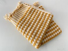 two yellow and white striped towels sitting on top of each other