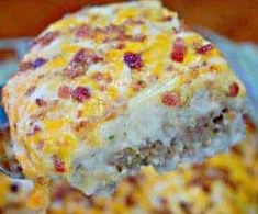 a close up of a piece of casserole with meat and cheese on it