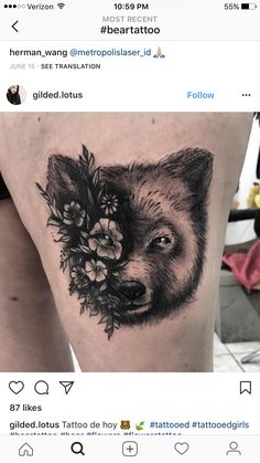 a black and white photo of a wolf with flowers on it's side thigh