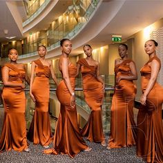 the beautiful women in orange dresses are posing together