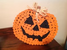 a pumpkin made out of orange circles on a table