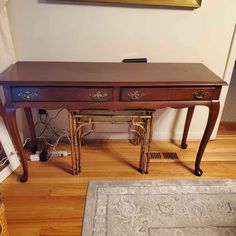 an antique desk with two drawers in the corner