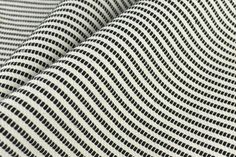 black and white striped fabric that is very close to the ground, with lines on it