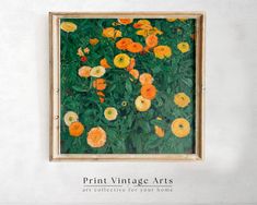 an art piece with orange and yellow flowers in a wooden frame on a white wall