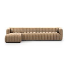 a beige couch sitting on top of a white floor