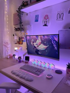 a desk with a keyboard, mouse and monitor on it in front of a purple light