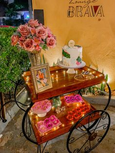 a table with flowers and cakes on it