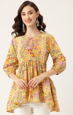 A beautiful hand block printed top perfect for holidays time . Jaipuri print along with the soothing Indian cotton fabric in yellow makes it comfortable to wear and pleasing to look at it . This Kurti features 3/4the sleeves and hip length with a tie up neck and sequinned embellishments . Perfect short Kurti blouse pairs well with denims and pants The panelling design makes for a stylish cut . Made with love by our artisans of jaipur ,India  Model is wearing size M  Size chart in pics Short Kurtis For Jeans Indian, Puff Sleeves Kurti, Short Kurtis For Jeans, Wedding Dresses Xl, Jaipuri Print, Kurti Top, Ethnic Motifs, Short Kurti, Indian Salwar Kameez