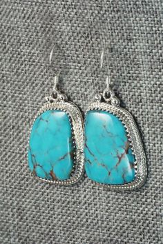 These Kingman turquoise and sterling silver earrings were made by Navajo silversmith Sharon McCarthy. The back is signed RB and stamped .925.Length: 1 1/2"Width: 3/4"Free shipping on all orders! We ship with USPS and always include tracking. All orders ship within a day of payment.Returns are accepted up to 30 days after you receive your order. Just send us a message. Our shop offers cash back or store credit. The item must be returned in new condition. Handmade Western Turquoise Earrings, Western Turquoise Nickel-free Earrings, Turquoise Nickel-free Western Earrings, Western Style Turquoise Nickel-free Earrings, Western Style Nickel-free Turquoise Earrings, Western Turquoise Dangle Earrings, Turquoise Dangle Earrings Western Style, Nickel Free Sterling Silver Western Earrings, Kingman Turquoise