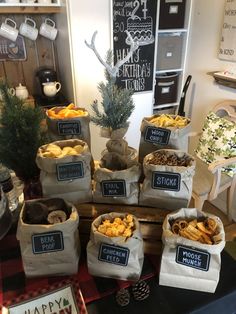 bags filled with food sitting on top of a table next to a christmas tree and other decorations