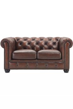 a brown leather couch with buttons on the arm and back, sitting against a white background