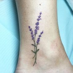 a small lavender flower tattoo on the ankle