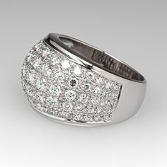 This wonderful domed ring is accented with seventy-five (75), bead set, round brilliant/single cut diamonds. The ring measures 13.7mm at the top, rises 5.9mm above the finger, tapering to 4.8mm wide and 1.0mm thick at the base of the shank. This ring is currently a size 6.5 and resizing is not recommended. Diamond Cocktail Ring, Diamond Cocktail Rings, Bead Set, Domed Ring, Cocktail Ring, Cocktail Rings, Round Brilliant, Diamond Cuts, Diamonds