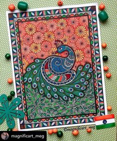 an art card with a peacock on it and beads around the edges, surrounded by flowers