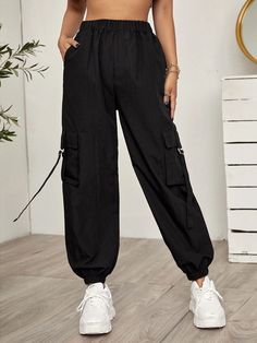 Add an edgy touch to your outfit with these black Tape Panel Flap Pocket Cargo Pants. These pants feature tape panel details that create a unique and eye-catching design element. The flap pockets on the sides add a functional and stylish touch, providing extra storage space. Made from high-quality materials, these cargo pants offer durability and comfort. Specifications: Style: Casual Type: Cargo Pants Details: Pocket, Tape Waist Line: High Waist Length: Cropped Fit Type: Regular Fit Fabric: Non Sporty High Waist Black Cargo Pants, Trendy Black Parachute Pants With Hip Pockets, Sporty Black Cargo Style Pants, Trendy Black Parachute Pants With Cargo Pockets, Trendy Black Parachute Pants With Side Pockets, Trendy Black Cargo Pants With Multiple Pockets, Trendy Black Cargo Pants With Pockets, Black High-waist Parachute Pants With Pockets, Black Sporty Parachute Pants With Multiple Pockets