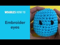 someone is holding up a crocheted blue object with the words woobles how to embroider eyes