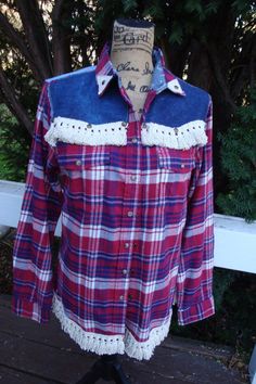 Really cute and rustic flannel with patched denim on back yoke and dark denim on front yokes. Fringe along bottom and front yokes with antique studs and canvas cross on back. This is a size small but fits more like a medium Plaid Flannel Shirt For Ranch In Fall, Fall Cotton Flannel Shirt For Rodeo, Western Cotton Flannel Shirt For Fall, Fall Plaid Flannel Shirt For Rodeo, Western Style Cotton Flannel Shirt For Rodeo, Plaid Flannel Shirt For Rodeo In Fall, Patched Denim, Rugged Cross, Flannel Fashion