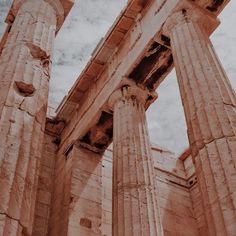 two large stone pillars in front of a cloudy sky