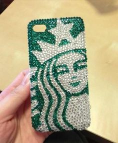 someone is holding up their phone case with the starbucks logo on it