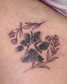 a close up of a person's stomach with a flower tattoo on her chest