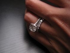 a woman's hand with a diamond ring on it