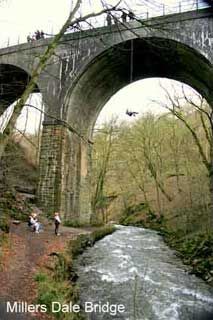 people are standing on the side of a bridge