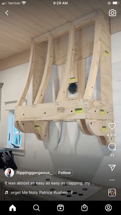 a wooden boat being built on top of a wall in a room with white walls