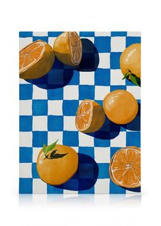 some oranges are on a blue and white checkered tablecloth