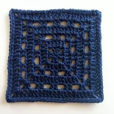 a crocheted square is shown on a white surface