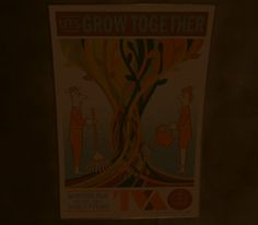 a poster hanging on the side of a wall in front of a door that says grow together