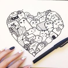 a woman's hand holding a pen and drawing a heart with doodles on it