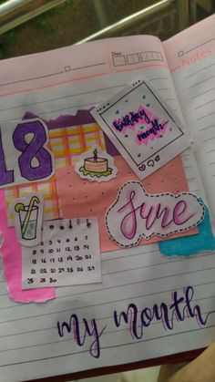 an open notebook with stickers on it and the words my month written in cursive writing