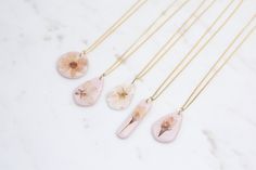 Hand picked and pressed, these wildflowers from the pacific northwest add a delicate and unique spin on polymer clay. With real flowers preserved in resin, each pendant is one of a kind.  Options:  - PENDANT + CHAIN: Gold plated, nickel and lead free, hypoallergenic chain. Adjustable chain (40cm, 45cm, and 50cm), Width 1.2mm - PENDANT ONLY: Use your own chain Items are made to order, and take 3-5 days to process. Design and flowers may vary slightly due to what we have in stock. Small bubbles in Pink Resin Jewelry With Pressed Flowers, Pendant Chain Gold, Cherry Blossom Necklace, Process Design, Resin Jewellery, The Pacific Northwest, Chain Gold, Real Flowers, Handmade Polymer Clay