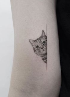 a cat's head is shown through the corner of a woman's arm