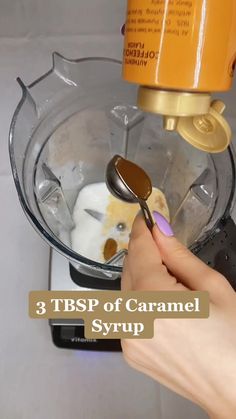 a person using a spoon to mix ingredients in a blender with the words 3 tsp of caramel syrup