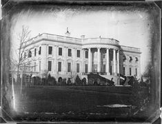 an old black and white photo of a large building with columns on the top floor