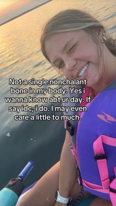 a woman in a life jacket smiles while sitting on a boat with the caption not a single nonchalant bone in my body, yes i wanna'd