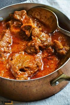 a large pot filled with meat and sauce